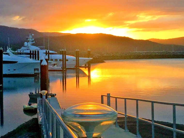 Still conditions at Airlie Beach make for a sensational sunset reflecting over the water