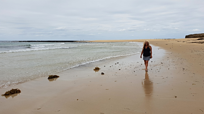 Adele walking along the beach